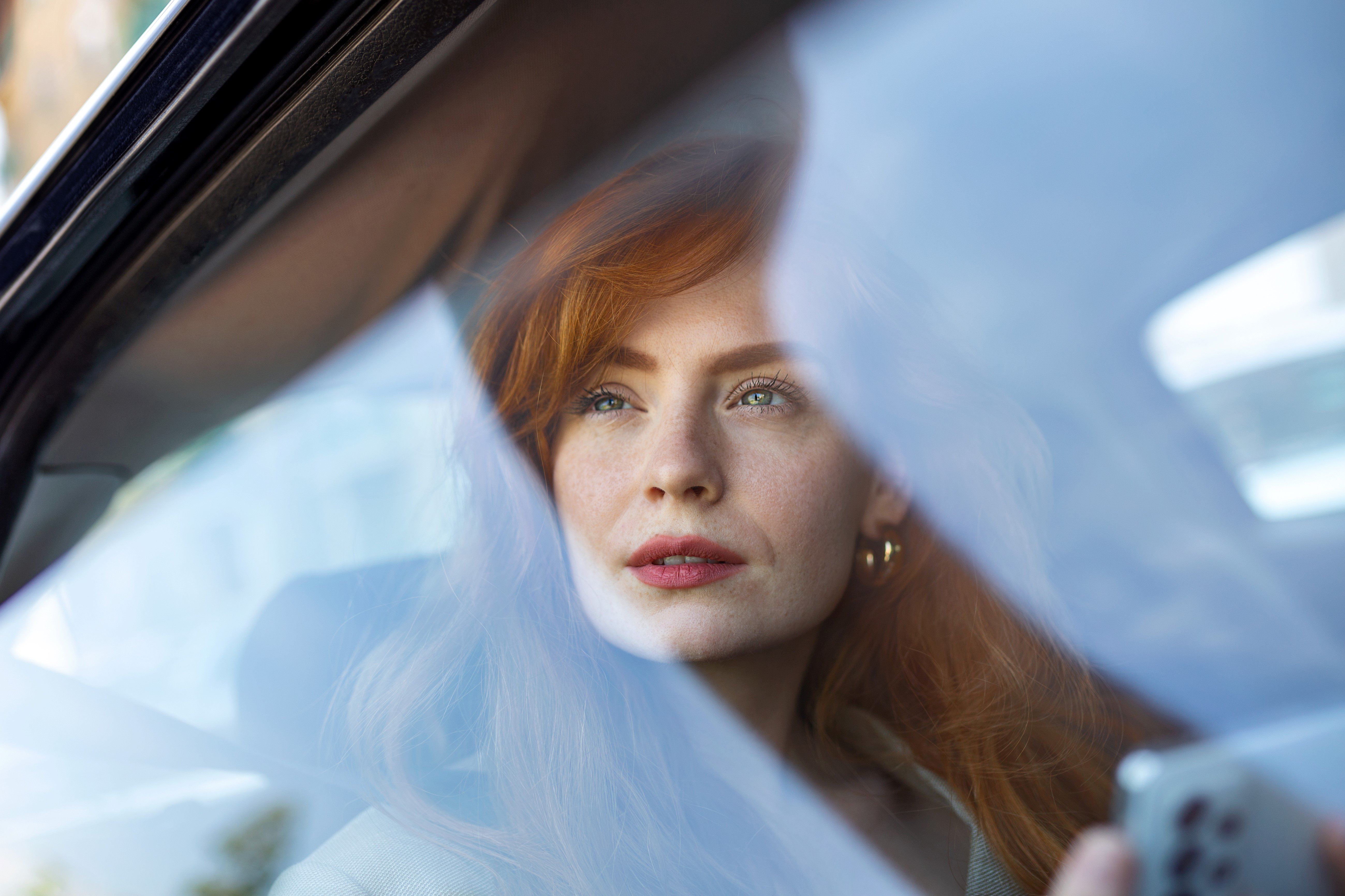 Woman with red lips in a car